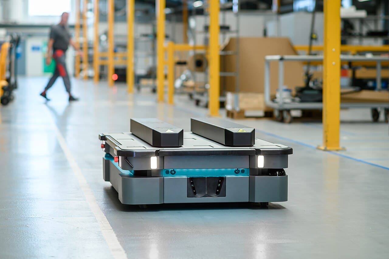 MiR autonomous mobile robot with a pallet-handling attachment on an industrial floor